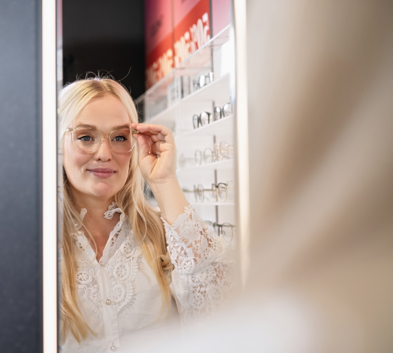 Kvinne med briller som ser i speil